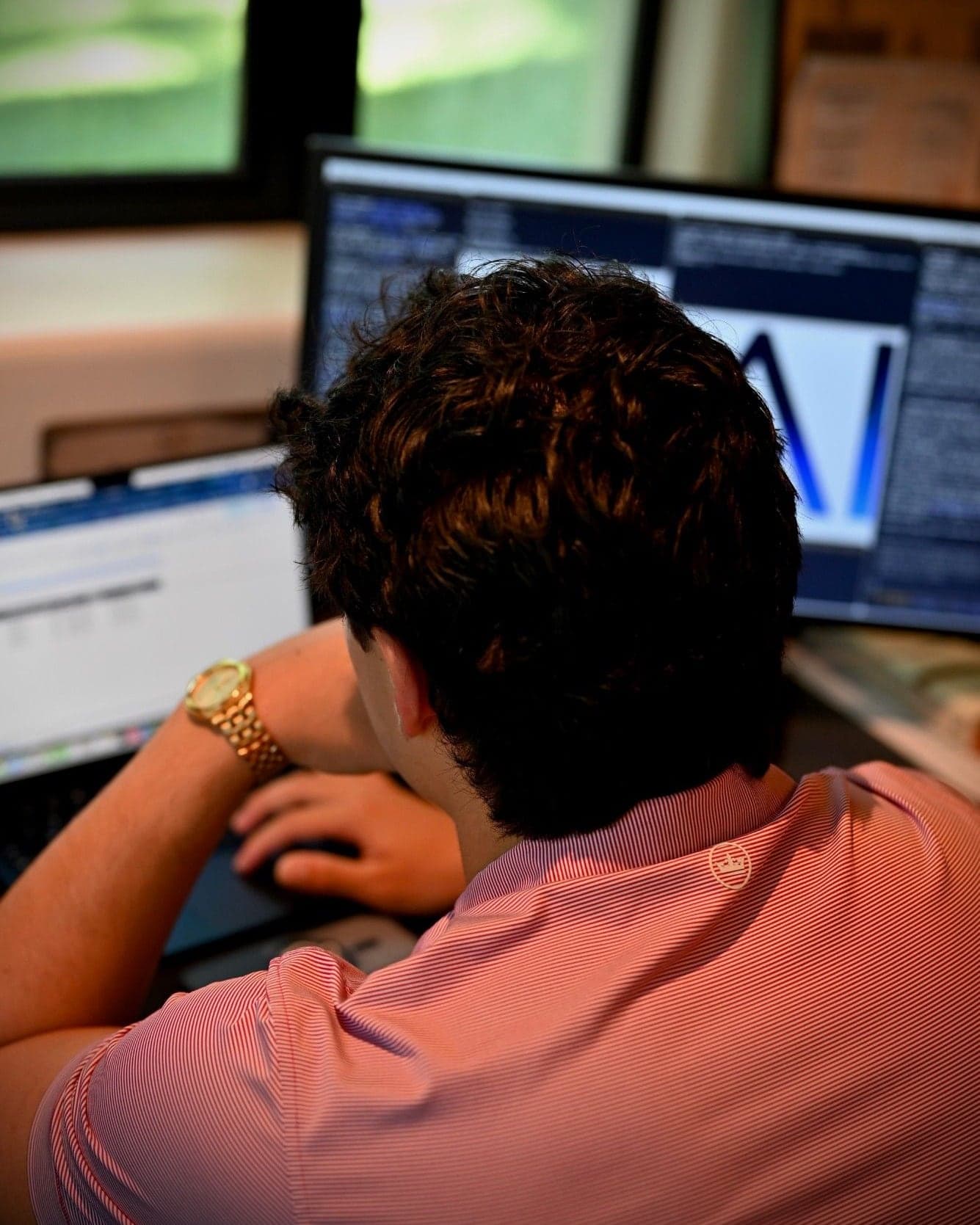 Roman at his desk, working on a 6AI build across two monitors